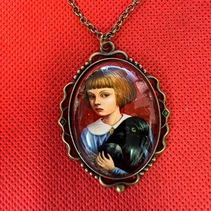 Child Holding a Black Crow with Red Background Oval Bronze Tone Pendant Necklace